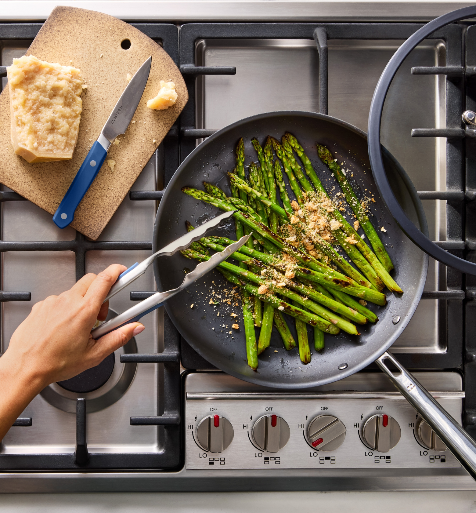 Sautéed asparagus with Parmesan in a nonstick skillet on a gas stove